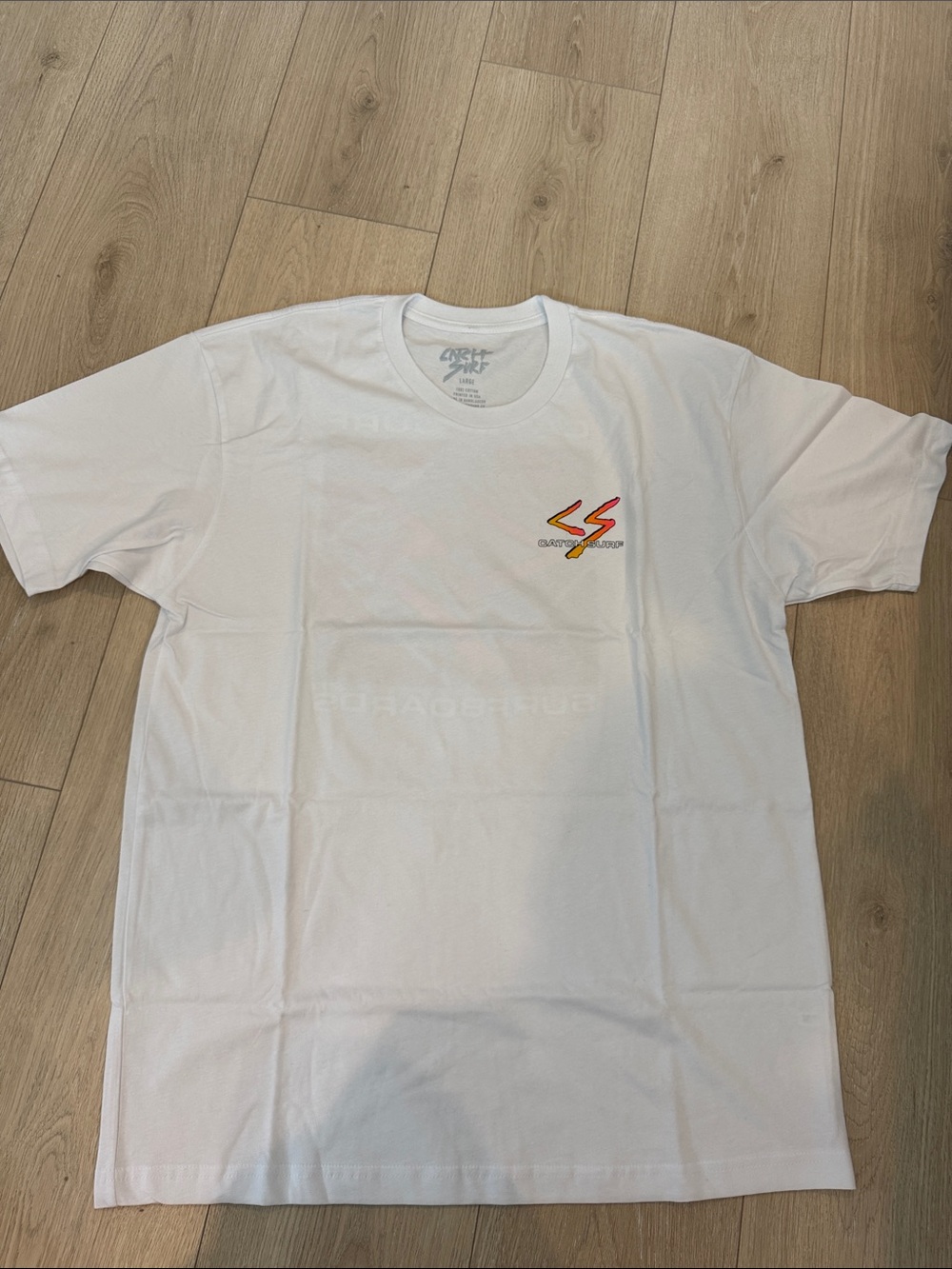 White Short-Sleeve Graphic Tee with Small Red-Yellow Chest Design